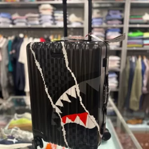 Center rip revealing gray check sprayground